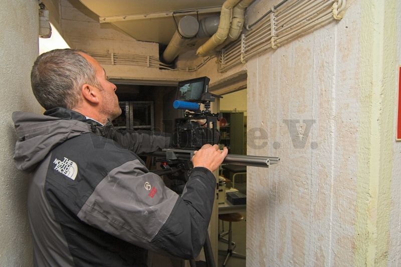 Der Kameramann des Drehteams bereitet eine Aufnahme im Bereich eines Rettungsraumes vor.