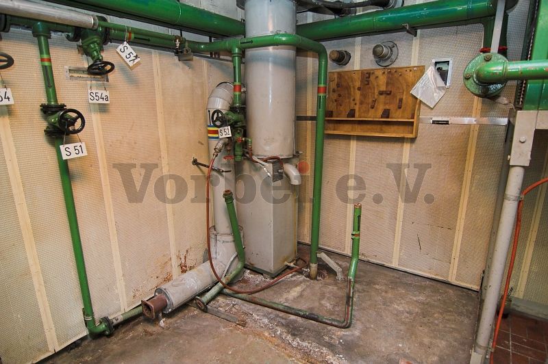 Kühlwasserleitungen, Abgasanlage und Wassereinbruchssicherung des Dieselmotors. Besonderheit: Die Kühlwasserleitung führt direkt in den Boden des Fernmeldebetriebsgebäudes.