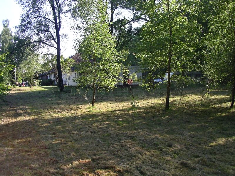 Blick über die gemähte Rasenfläche des GSVBw-Geländes in Richtung Unterkunftsgebäude.