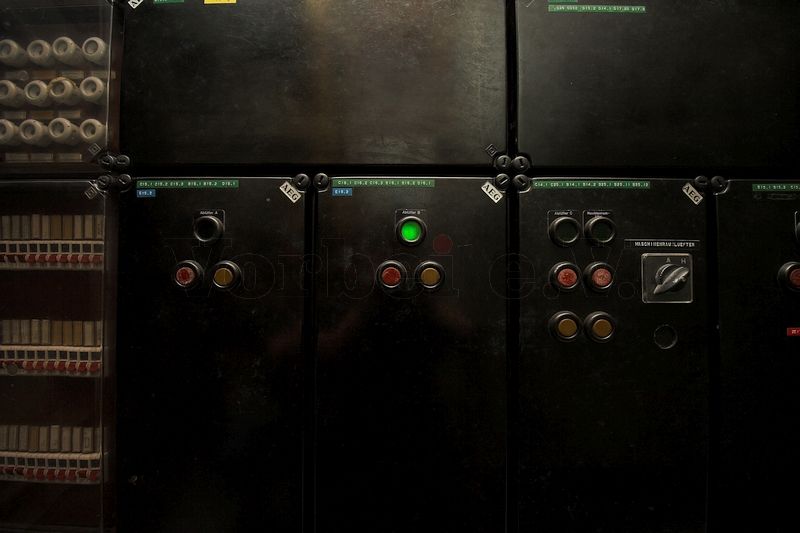 Das Foto zeigt einen Ausschnitt des Hauptschaltfeldes im Museumsbunker Hannover. Der mittlere Schaltkasten beinhaltet die Bedienelemente und die Stern-Dreieck-Ansteuerung für das Abluftgebläse „B“. Die leuchtende Kontrolllampe signalisiert, dass das Abluftgebläse bereits in Dreieckschaltung betrieben wird.